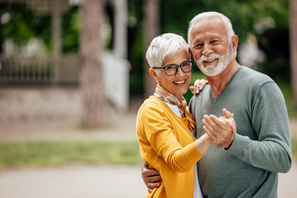 Portrait of senior couple, practicing their dance moves, while posing.