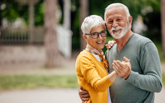 Portrait of senior couple, practicing their dance moves, while posing.